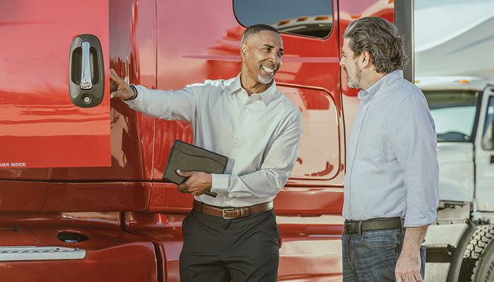 Two men looking at truck
