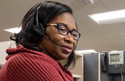 Black_woman_with_headset_on_at_desk